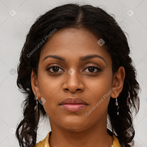 Joyful black young-adult female with long  brown hair and brown eyes