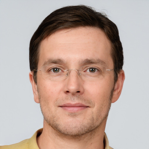 Joyful white adult male with short  brown hair and grey eyes