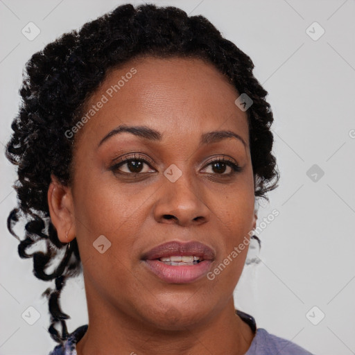 Joyful black adult female with short  brown hair and brown eyes