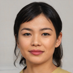 Joyful asian young-adult female with medium  black hair and brown eyes