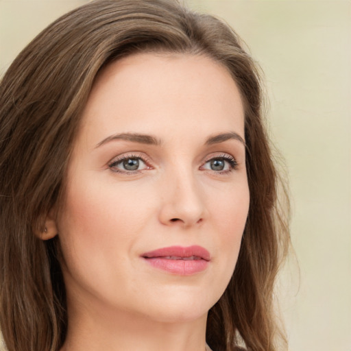 Joyful white young-adult female with long  brown hair and green eyes