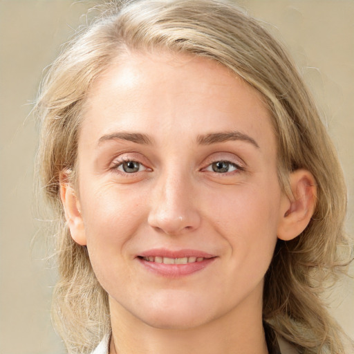 Joyful white young-adult female with medium  brown hair and blue eyes