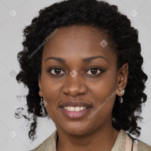 Joyful black young-adult female with long  brown hair and brown eyes