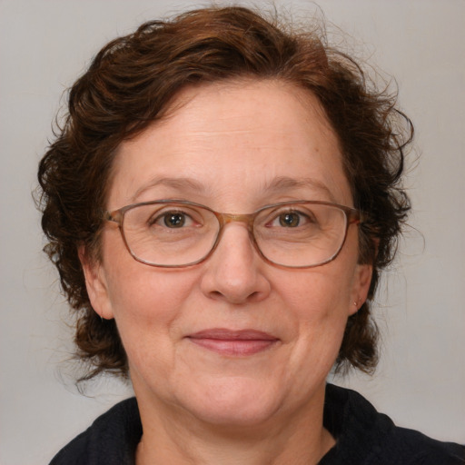 Joyful white middle-aged female with medium  brown hair and blue eyes