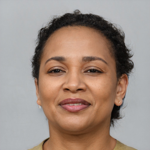 Joyful latino adult female with short  brown hair and brown eyes