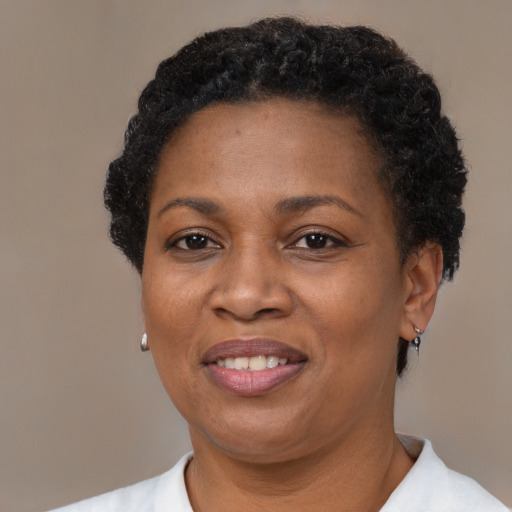 Joyful black adult female with short  black hair and brown eyes