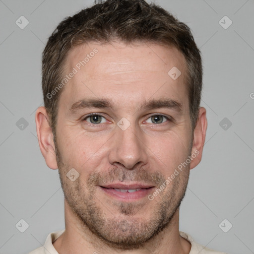 Joyful white adult male with short  brown hair and grey eyes