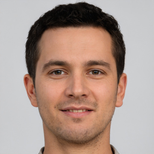 Joyful white young-adult male with short  brown hair and brown eyes