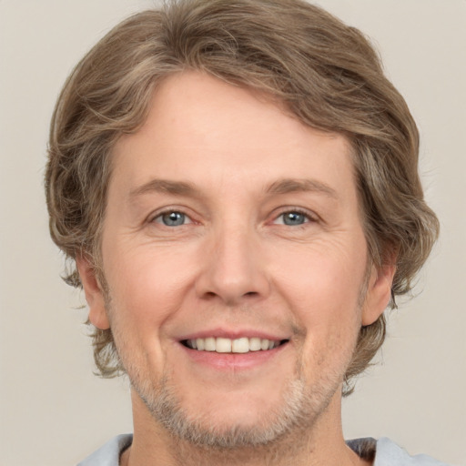 Joyful white adult male with short  brown hair and grey eyes