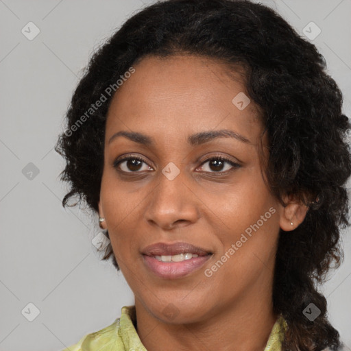 Joyful black young-adult female with long  brown hair and brown eyes