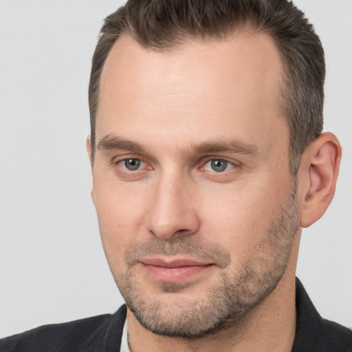 Joyful white adult male with short  brown hair and brown eyes