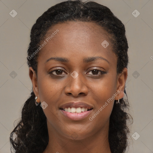 Joyful black young-adult female with long  brown hair and brown eyes