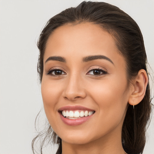 Joyful white young-adult female with long  brown hair and brown eyes