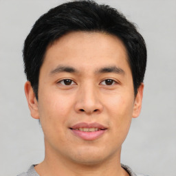 Joyful asian young-adult male with short  black hair and brown eyes