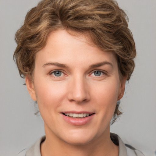 Joyful white young-adult female with medium  brown hair and blue eyes