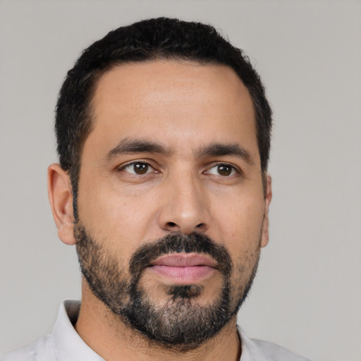 Neutral latino adult male with short  black hair and brown eyes