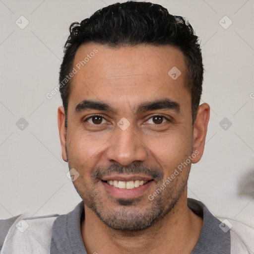 Joyful white young-adult male with short  black hair and brown eyes