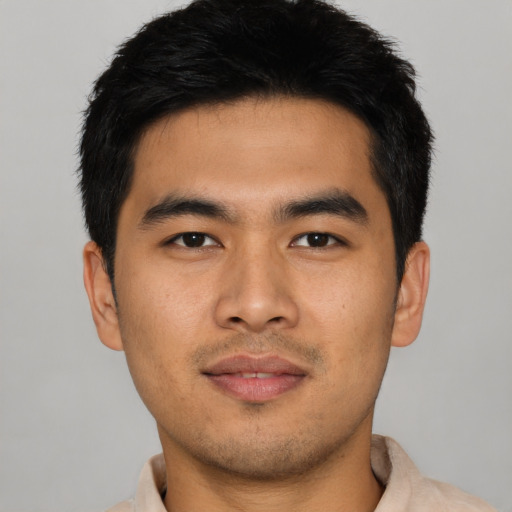 Joyful asian young-adult male with short  black hair and brown eyes