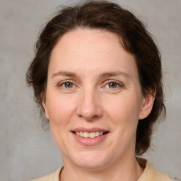 Joyful white adult female with medium  brown hair and grey eyes