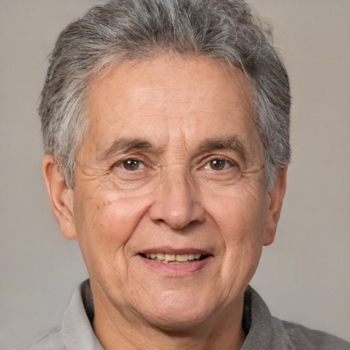 Joyful white middle-aged male with short  gray hair and brown eyes