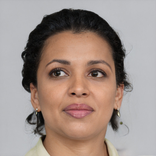 Joyful latino young-adult female with short  brown hair and brown eyes