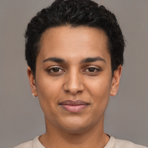 Joyful latino young-adult female with short  black hair and brown eyes