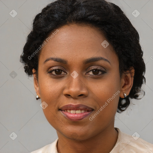 Joyful black young-adult female with short  black hair and brown eyes