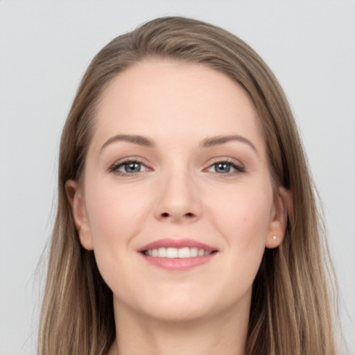 Joyful white young-adult female with long  brown hair and grey eyes