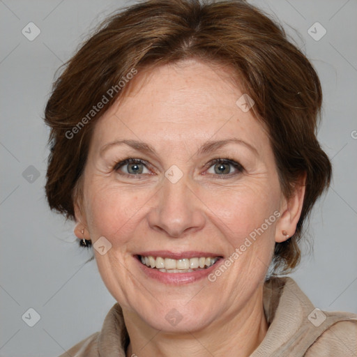 Joyful white adult female with medium  brown hair and blue eyes