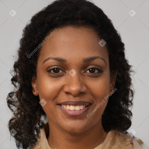 Joyful black young-adult female with long  brown hair and brown eyes