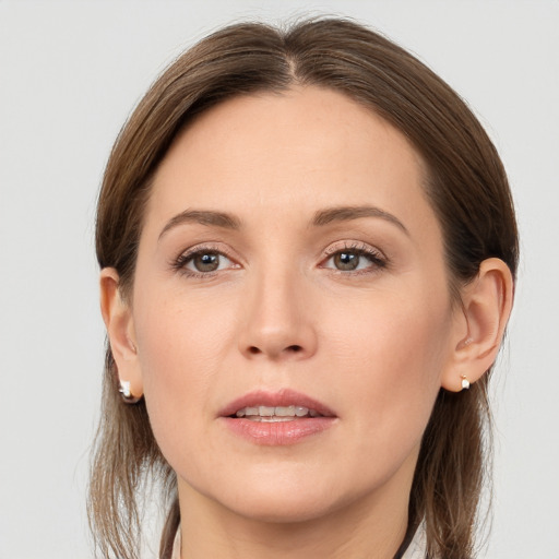 Joyful white young-adult female with long  brown hair and grey eyes