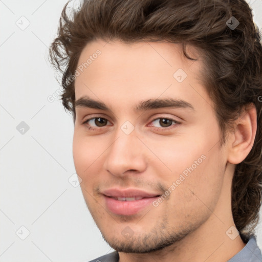 Joyful white young-adult male with medium  brown hair and brown eyes