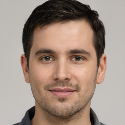 Joyful white young-adult male with short  brown hair and brown eyes