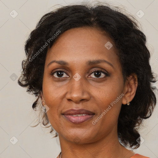 Joyful black adult female with medium  brown hair and brown eyes