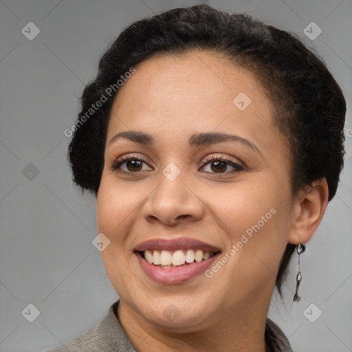 Joyful black adult female with short  brown hair and brown eyes