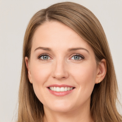 Joyful white young-adult female with long  brown hair and grey eyes