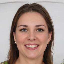 Joyful white young-adult female with long  brown hair and grey eyes