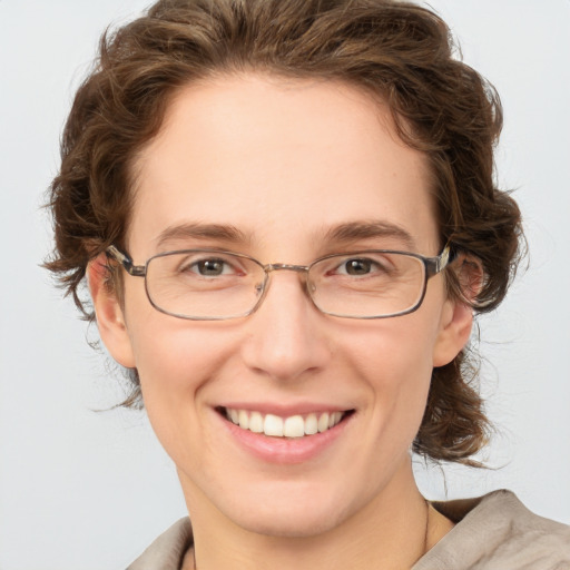 Joyful white adult female with medium  brown hair and blue eyes