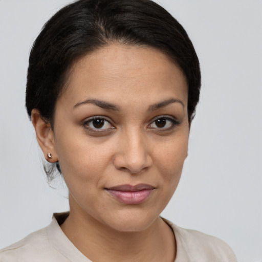 Joyful latino young-adult female with short  brown hair and brown eyes