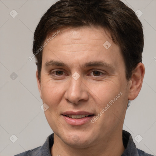 Joyful white adult male with short  brown hair and brown eyes