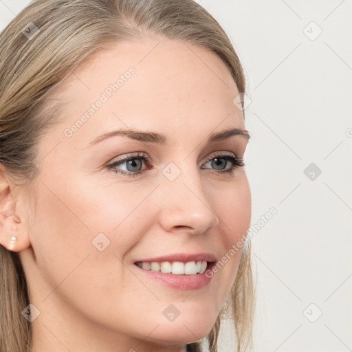 Joyful white young-adult female with long  brown hair and blue eyes