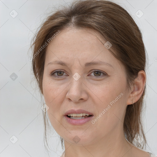 Joyful white adult female with medium  brown hair and brown eyes