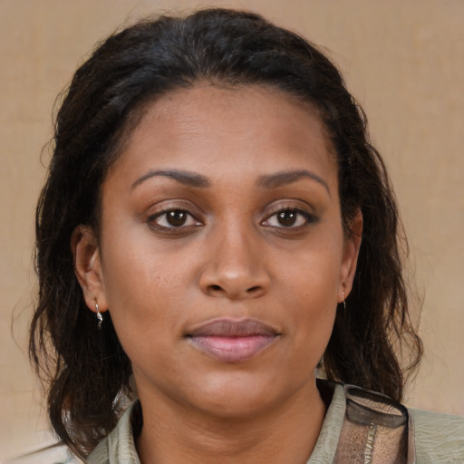 Joyful black young-adult female with medium  brown hair and brown eyes