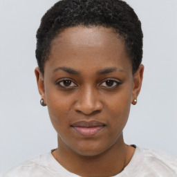 Joyful black young-adult female with short  black hair and brown eyes