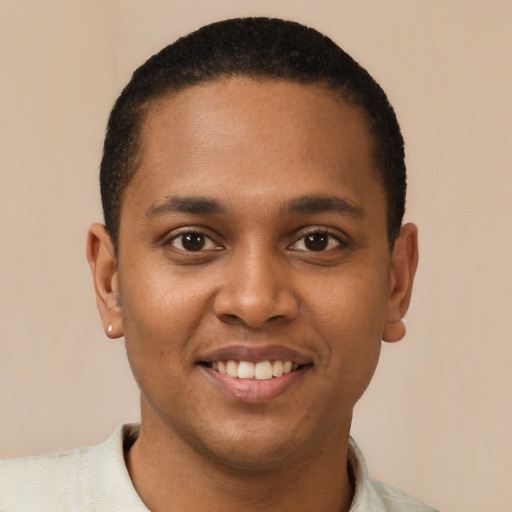 Joyful black young-adult male with short  black hair and brown eyes