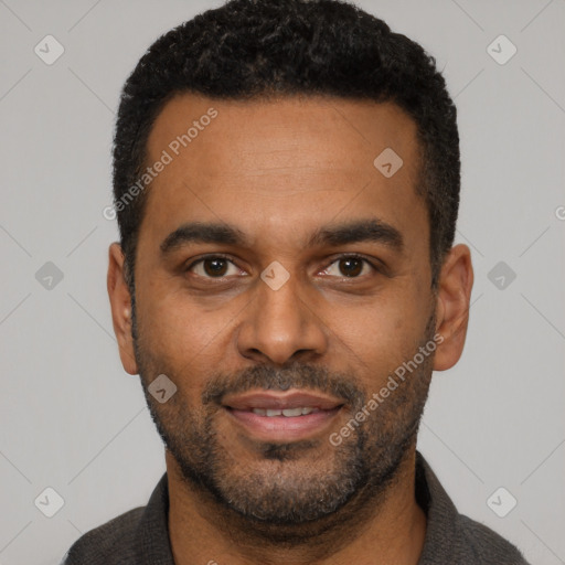 Joyful latino young-adult male with short  black hair and brown eyes