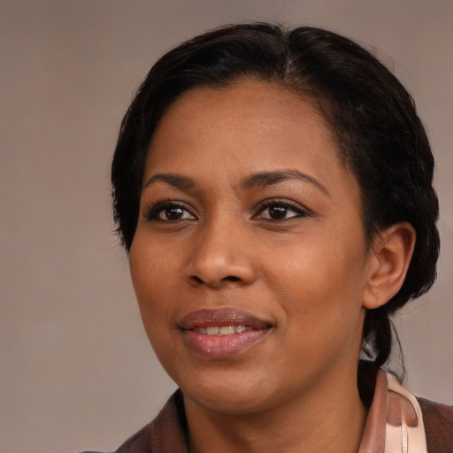 Joyful black young-adult female with medium  black hair and brown eyes