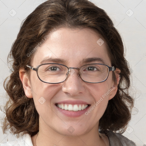 Joyful white adult female with medium  brown hair and blue eyes