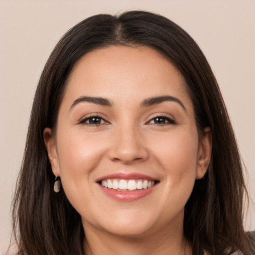 Joyful white young-adult female with long  brown hair and brown eyes