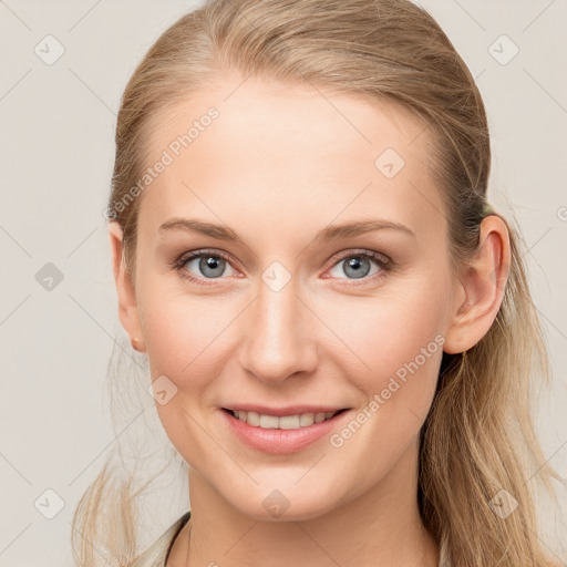 Joyful white young-adult female with long  brown hair and blue eyes